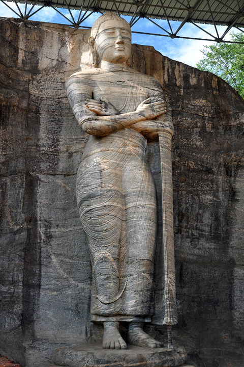 Rock-cut Buddha statue with Svastika Mudra