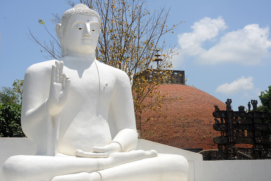 Sitting Buddha in front of Anubuddhu Mihindu Mahaseya in Mihintale