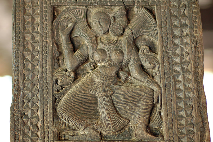 Apsara depicted on a woodcarving in Embekke in Sri Lanka