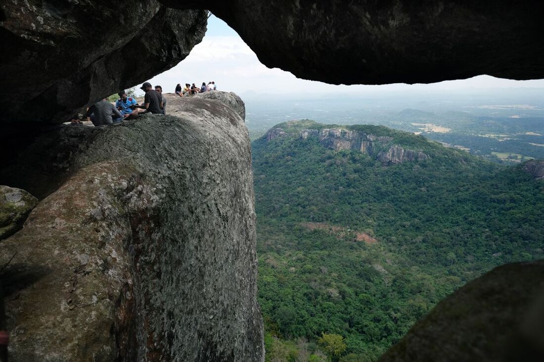 view from Dolukanda cave to the vertical cliff of the mountain near Arankale