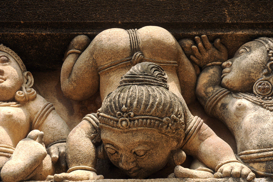 carvings of playful dwarfs at the Kelaniya temple