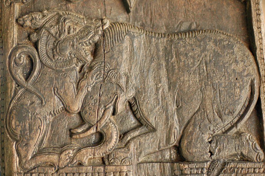 lion attacking elephant depicted on a woodcarving in Embekke