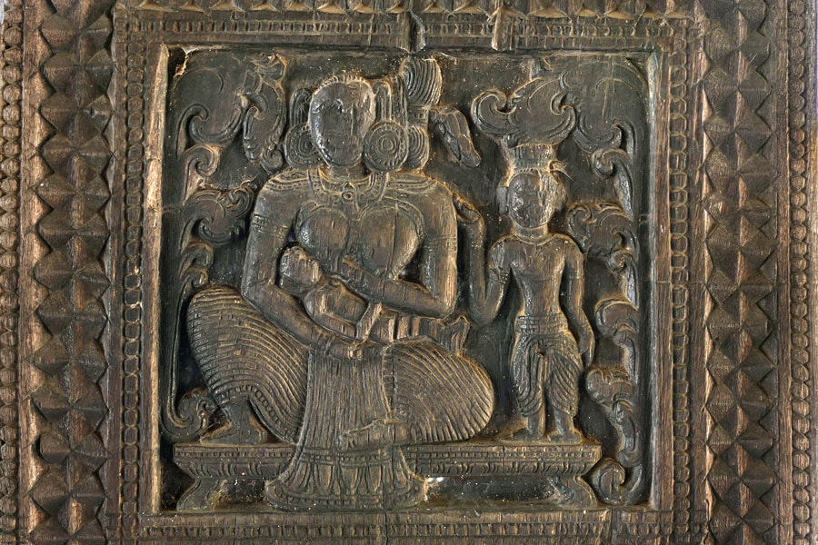 nursing scene depicted in the Embekke temple in Sri Lanka
