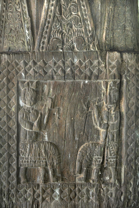 Panavitiya Ambalama woodcarving of chatting seated men
