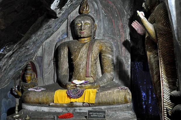 Sitting and standing Buddha in the rock chapel of Yapahuwa