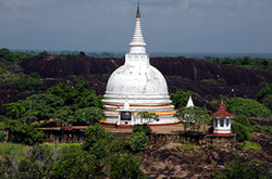 white stupas on dark granite rocks are typical of Sri Lanka